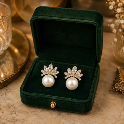 Gold Pearl Crown Stud Earrings displayed in a deep green velvet jewellery box