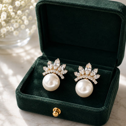 Pearl Crown Stud Earrings in gold displayed in a deep green velvet jewellery box