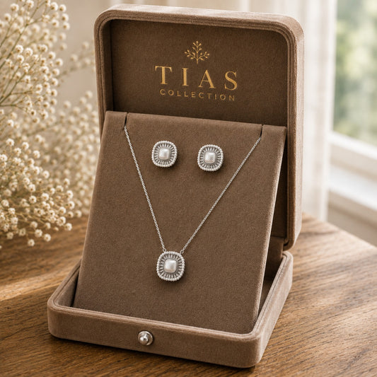 Silver-tone pearl pendant and matching stud earrings with square pearl centres and detailed frames