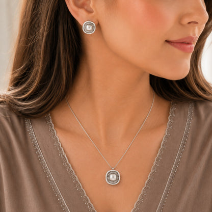 Model wearing matching silver pearl stud earrings and pendant necklace set