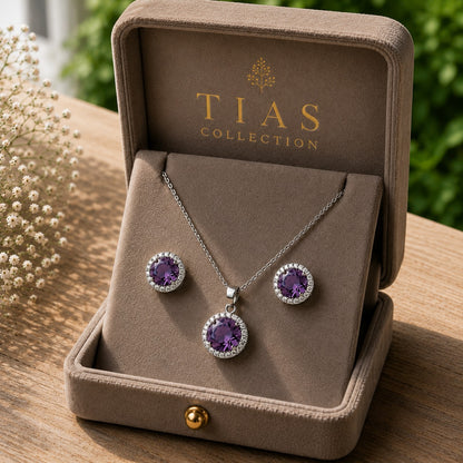 iolet Ember pendant and earring set with faceted purple centre stones, clear zircon surrounds and silver-tone finish.