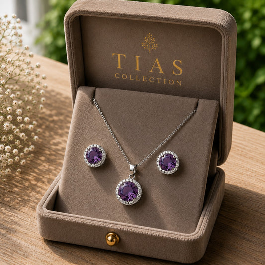 iolet Ember pendant and earring set with faceted purple centre stones, clear zircon surrounds and silver-tone finish.