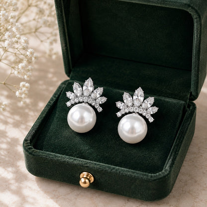 Pearl Crown Stud Earrings in silver displayed in a deep green velvet jewellery box