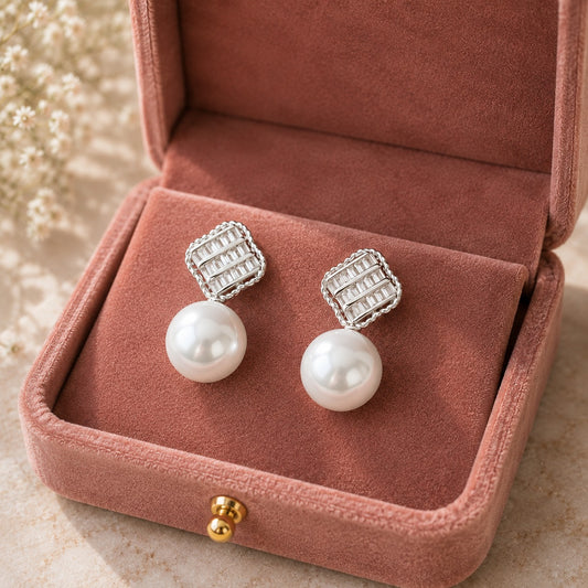 Close-up of Pearl Grid Drop Earrings displayed in a dusty rose velvet jewellery box