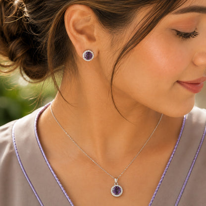 Model wearing the Violet Ember purple zircon pendant and matching stud earrings in a polished silver-tone settin