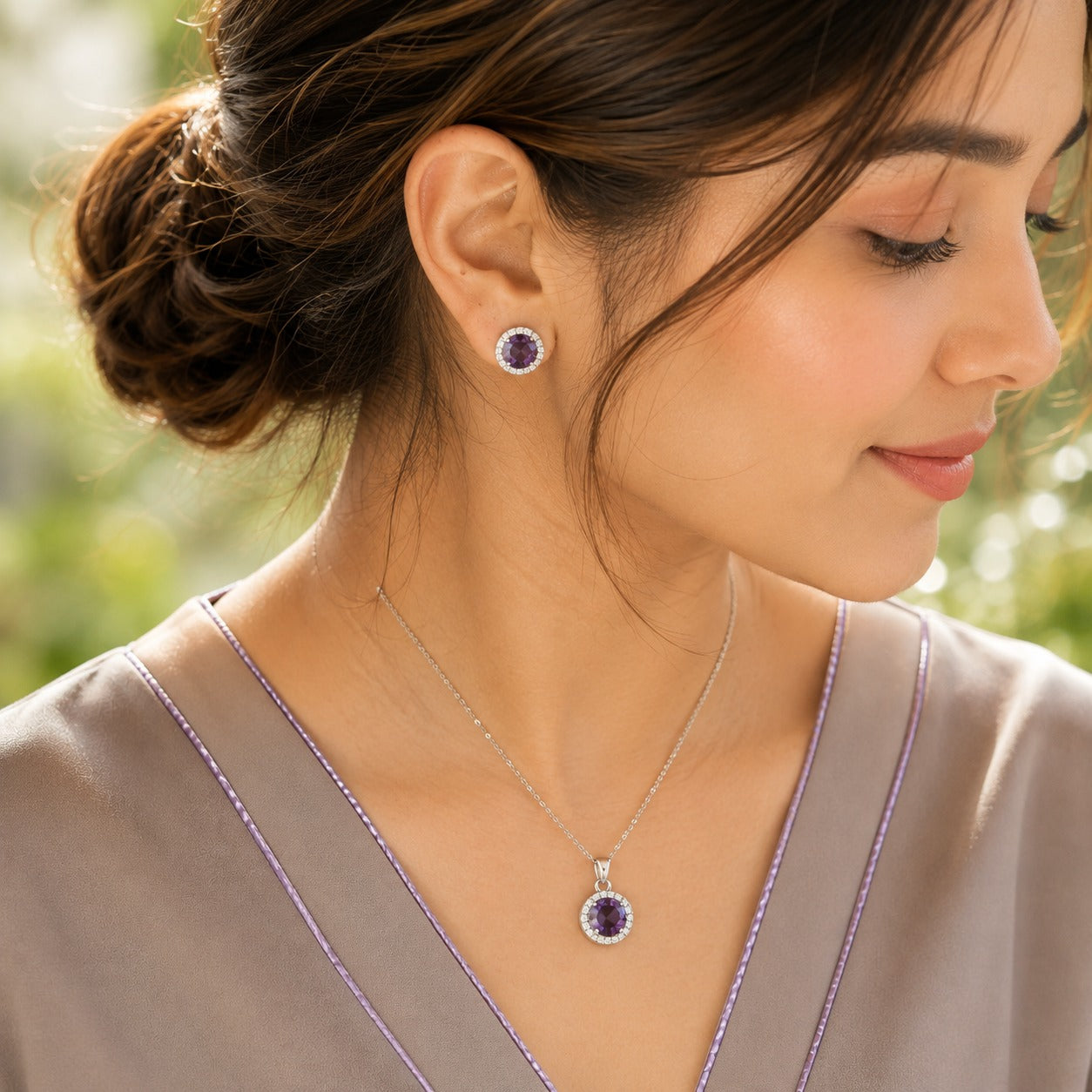 Model wearing the Violet Ember purple zircon pendant and matching stud earrings in a polished silver-tone settin