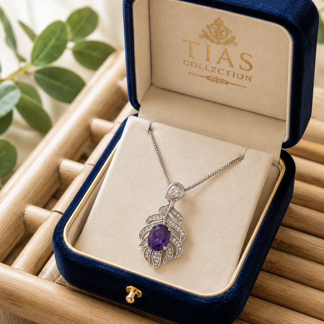 Deep Purple Plume Arc Pendant displayed in a jewellery box, featuring a faceted purple centre stone and sculpted silver-tone zircon design.