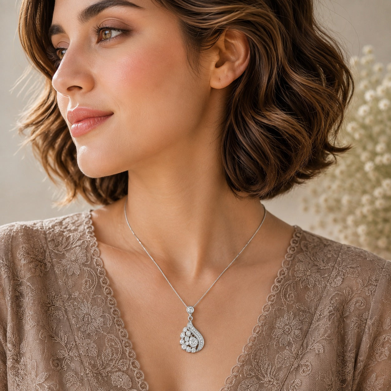 Model wearing silver crystal drop pendant necklace with asymmetric sparkling design