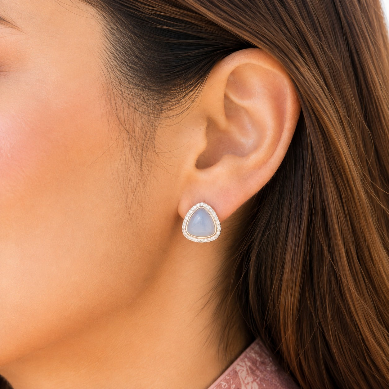 Close-up of Glacier Cove Studs featuring a misty ice-blue triangular centre framed with clear zircon.