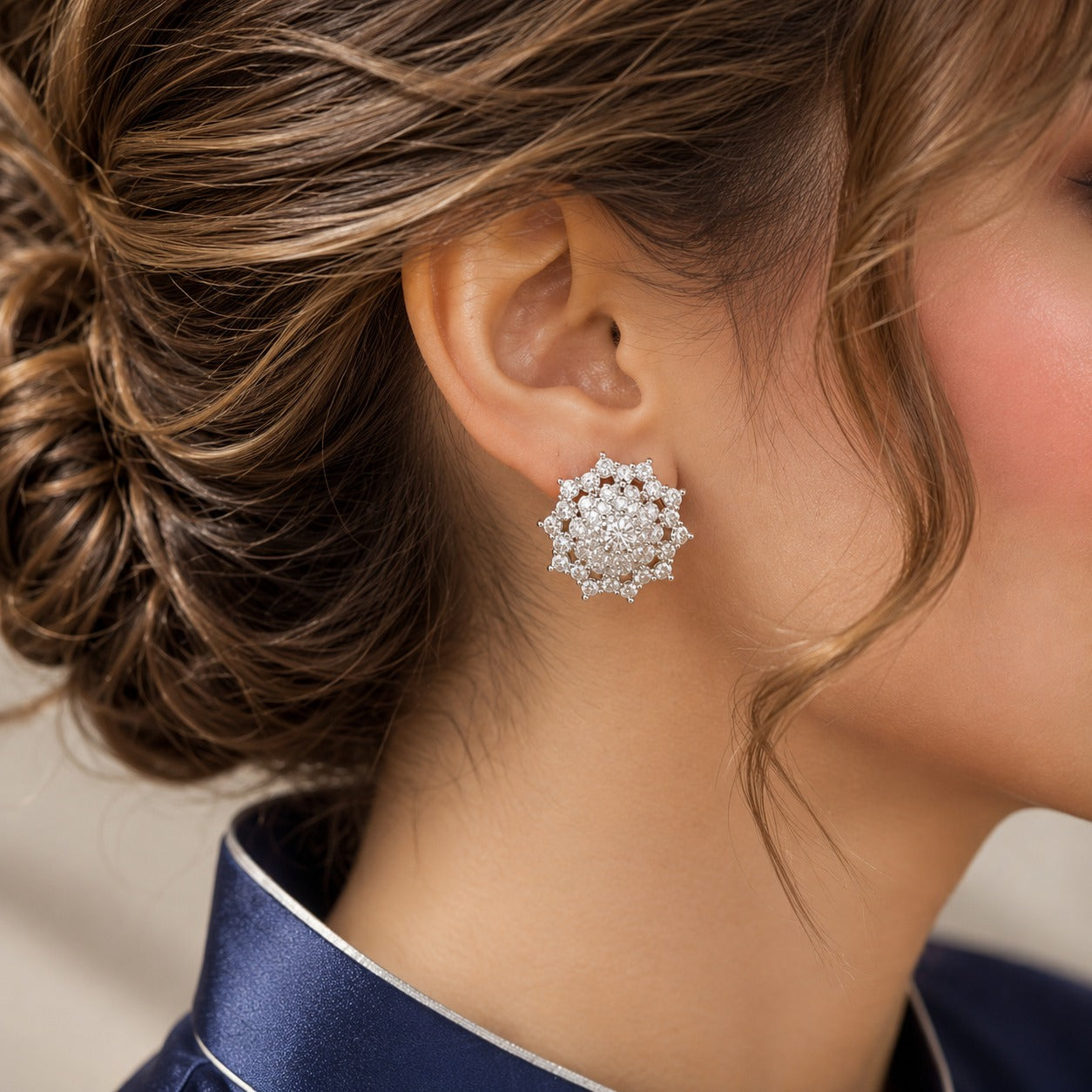 Close-up of Astra Crest clear zircon statement stud earring worn on the ear, showing its intricate dimensional cluster design