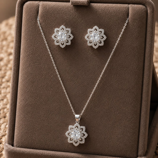Solenne clear zircon pendant and matching stud earrings displayed on a taupe jewellery stand.