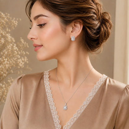 Model wearing Lucent Frame silver-tone clear zircon pendant necklace and matching rectangular stud earrings.