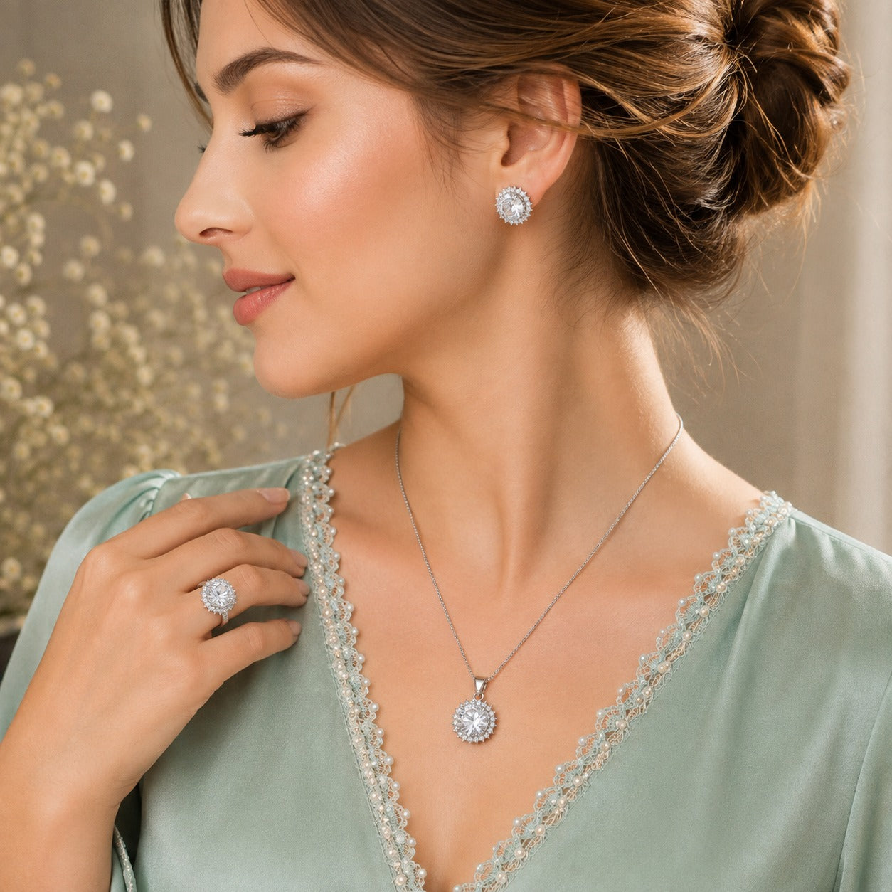 Model wearing matching clear zircon stud earrings, pendant necklace and statement ring in a silver-tone setting.