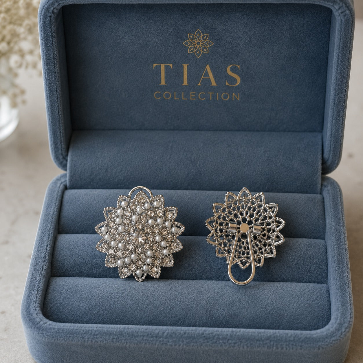 Back view of silver-tone pearl and crystal statement earrings showing the detailed openwork construction and clip-style fastening.
