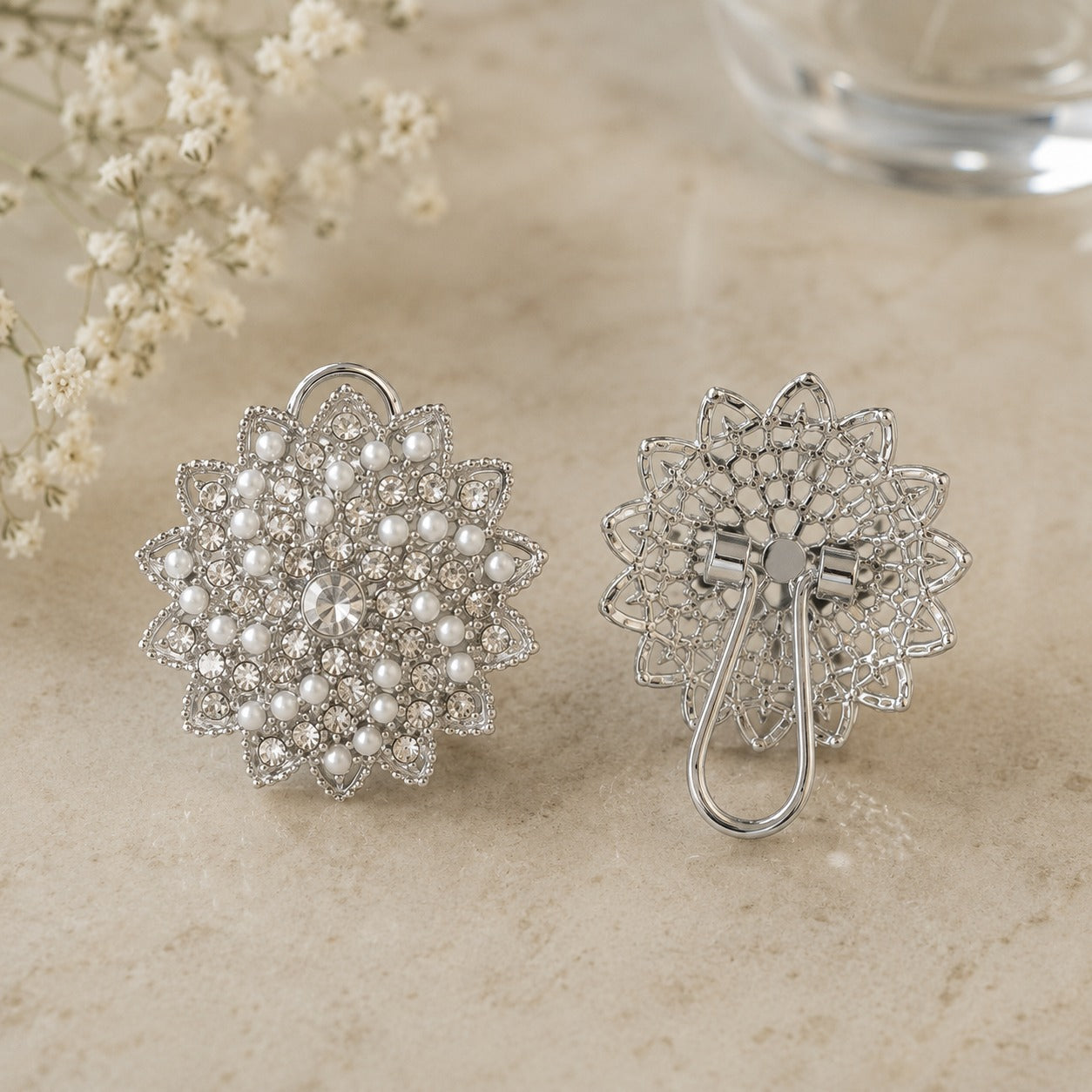 Back view of silver-tone pearl and crystal statement earrings showing the detailed openwork construction and clip-style fastening.