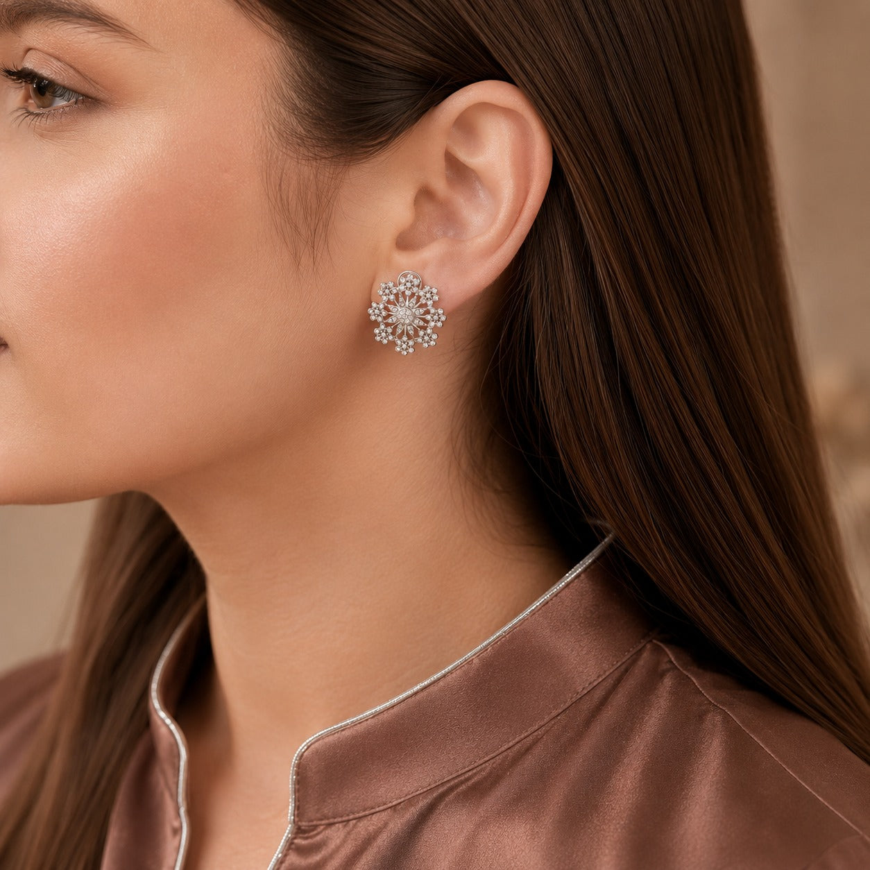 Silver-tone crystal floral earring worn on the ear, showing its detailed circular flower-cluster design and statement size.