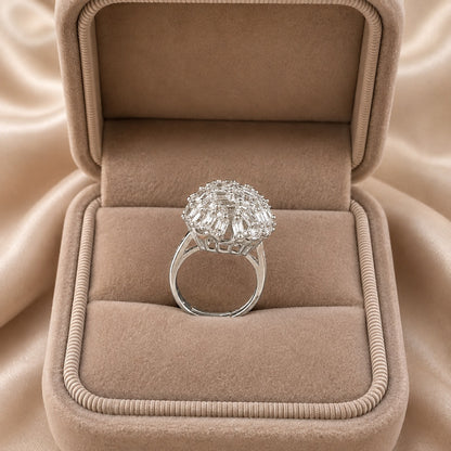 Prism Nest S925 silver ring displayed in a beige jewellery box, showing its raised round cluster and polished silver band.