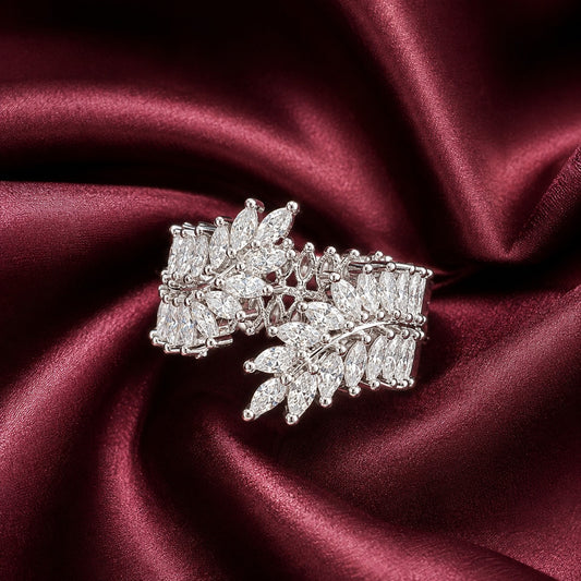 Front close-up of S925 silver statement band with overlapping marquise clear stones displayed on deep burgundy satin.
