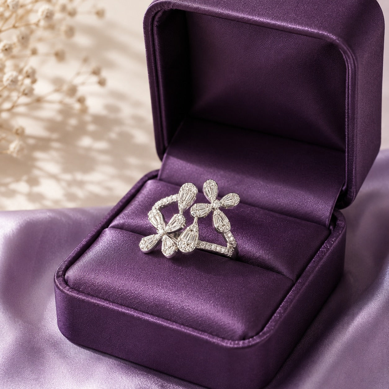 S925 silver floral ring in size 8 presented inside a rich purple jewellery box, showing its curved open design and clear stone detailing.