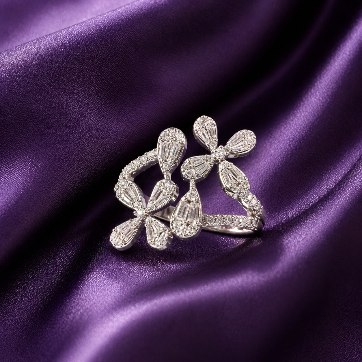 S925 silver Petal Drift Ring with clear tapered petal stones and an open asymmetrical floral design displayed on deep purple satin.