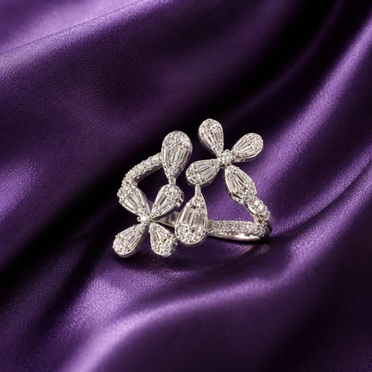 S925 silver Petal Drift Ring with clear tapered petal stones and an open asymmetrical floral design displayed on deep purple satin.