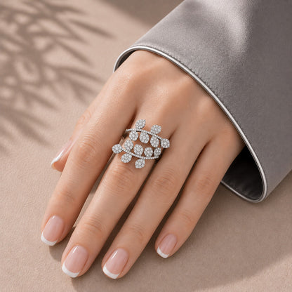 Branchline S925 silver zircon leaf ring worn on a hand with French manicure and soft grey satin sleeve.