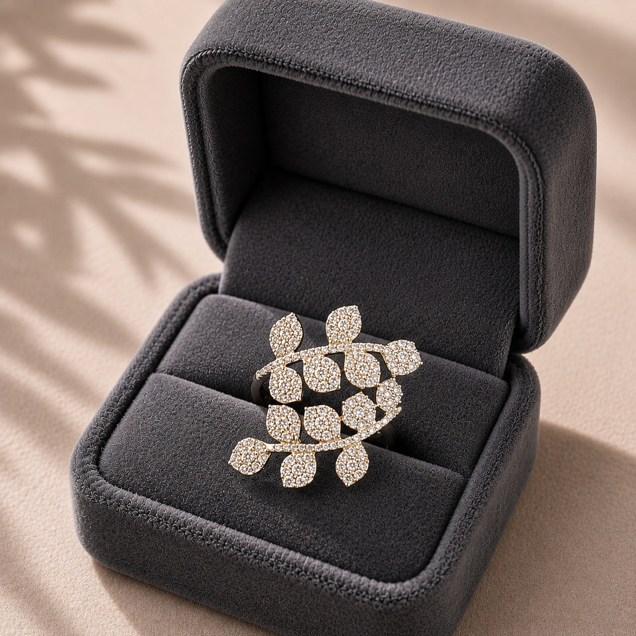 Branchline S925 silver ring with clear zircon pavé leaves displayed in a charcoal grey jewellery box.