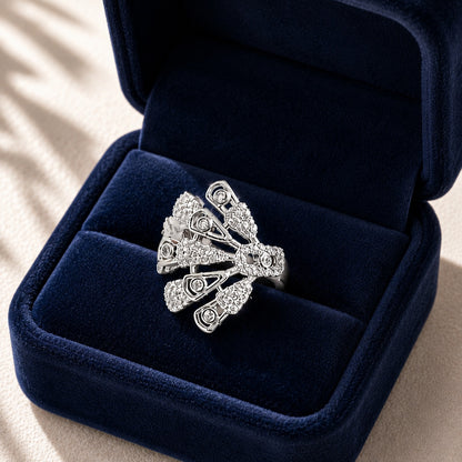 Silver statement ring presented in a deep navy velvet jewellery box, highlighting its intricate fan-shaped zircon design.