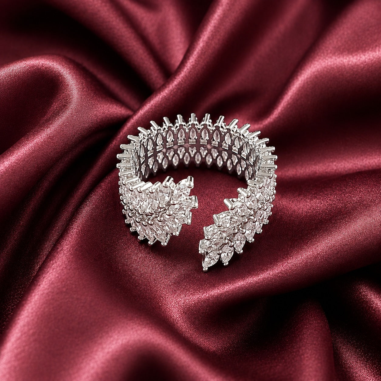Angled view of the Vela Wrap Band showing its wide multi-row construction, open ends and intricate marquise stone setting.