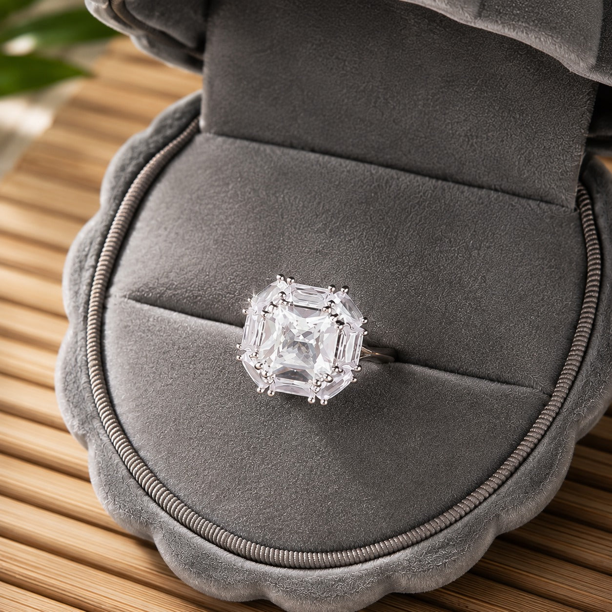 Cutglass Square S925 silver ring featuring a clear square centre stone and geometric baguette-cut surround displayed in a grey jewellery b
