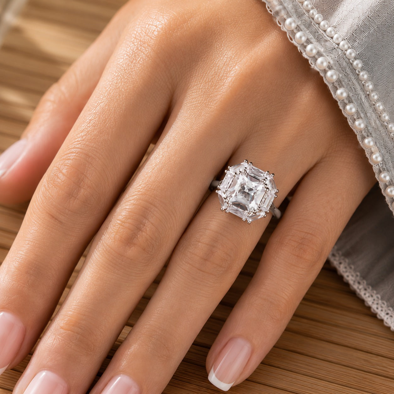 Cutglass Square S925 silver ring with a clear square-cut centre stone and baguette stone surround worn on the hand.