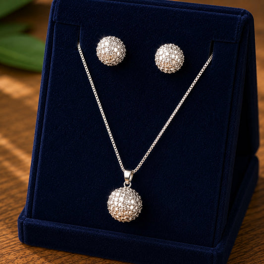 Lattice Dome Set featuring silver-tone dome earrings and matching pendant necklace with intricate openwork and pearly-white accents in a navy velvet jewellery box.