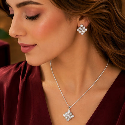 Model wearing S925 silver geometric clear stone earrings with matching pendant necklace.