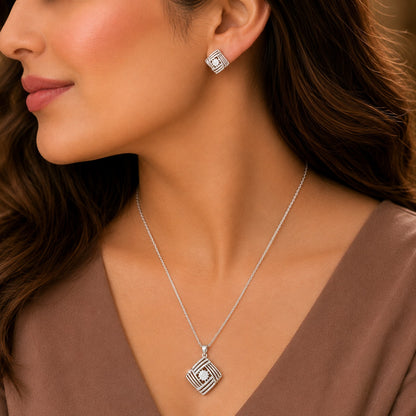 Model wearing the S925 Linear Muse geometric pendant necklace with matching silver stud earrings.