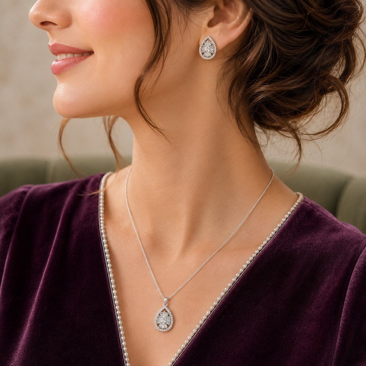 Dropline S925 silver teardrop pendant necklace with matching zircon stud earrings worn together with a deep plum outfit.