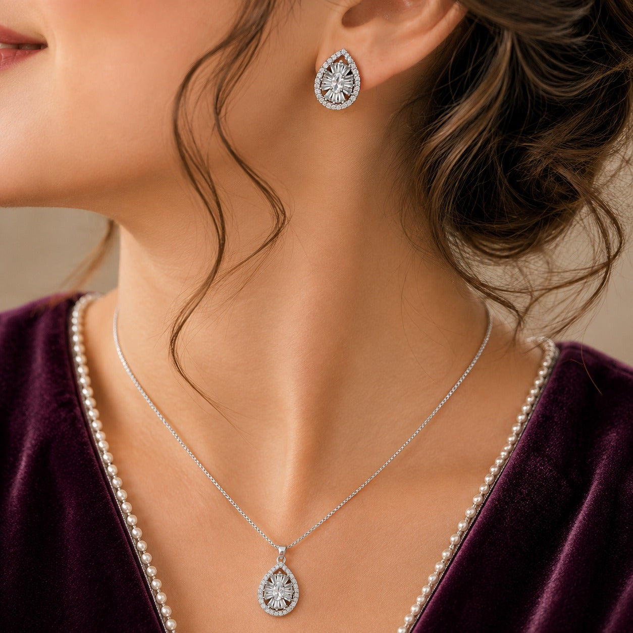 Dropline S925 silver teardrop pendant necklace with matching zircon stud earrings worn together with a deep plum outfit.