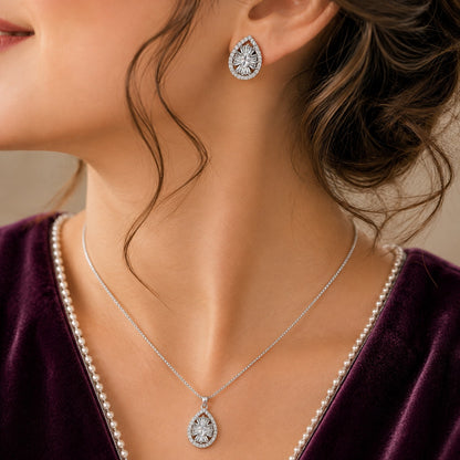 Dropline S925 silver teardrop pendant necklace with matching zircon stud earrings worn together with a deep plum outfit.