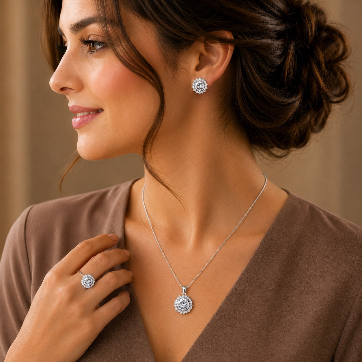 Model wearing the S925 silver Solara Crest earrings, pendant necklace and matching ring featuring brilliant round clear stones.