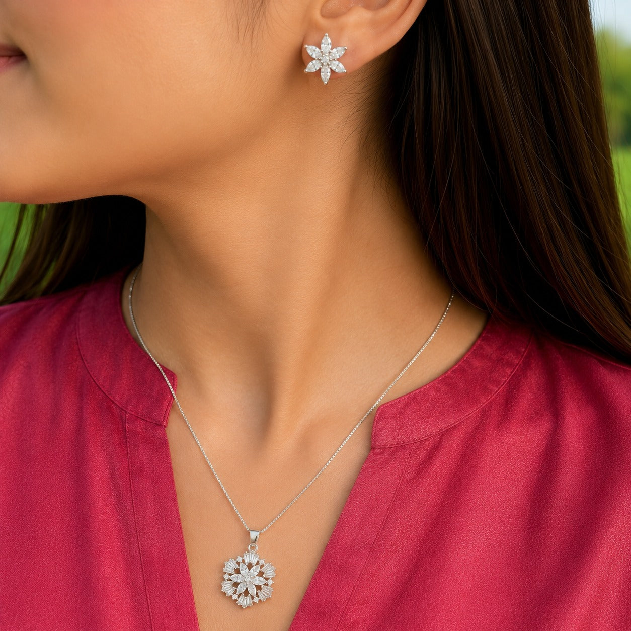 Model wearing the S925 Petal Array pendant necklace with matching clear stone floral stud earrings.