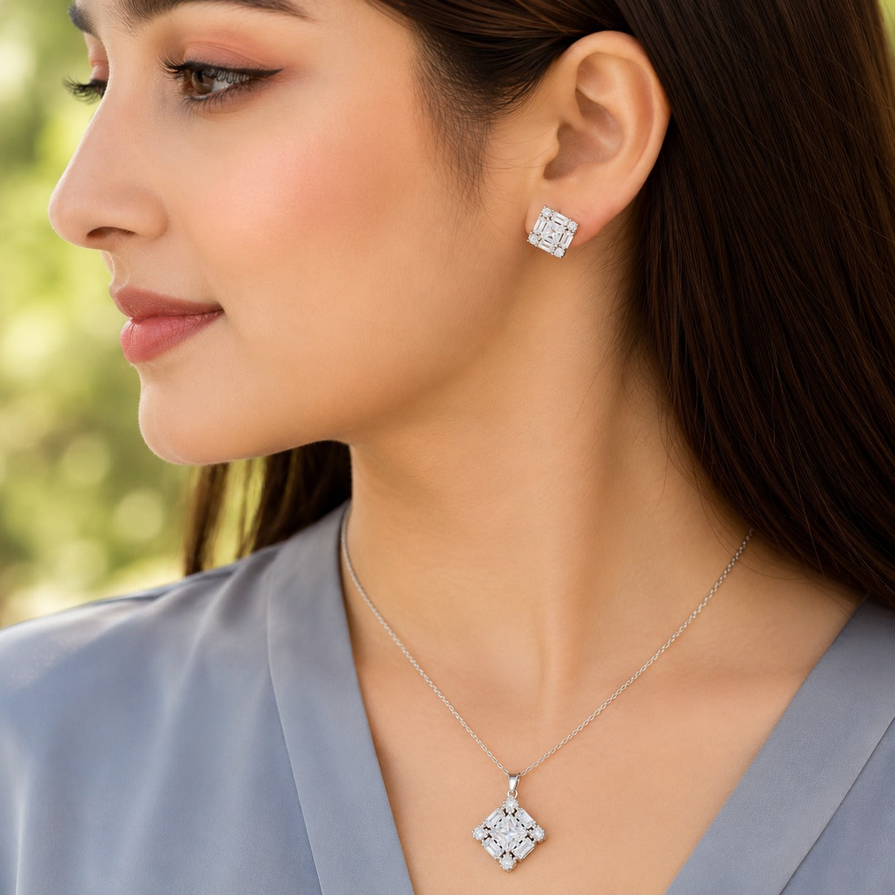 Facet Grid S925 silver pendant necklace with matching geometric square stud earrings worn in a close-up styling image
