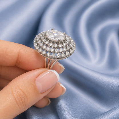 S925 Lucent Lace statement ring with oval clear centre stone and intricate crystal lattice design held inn hand.
