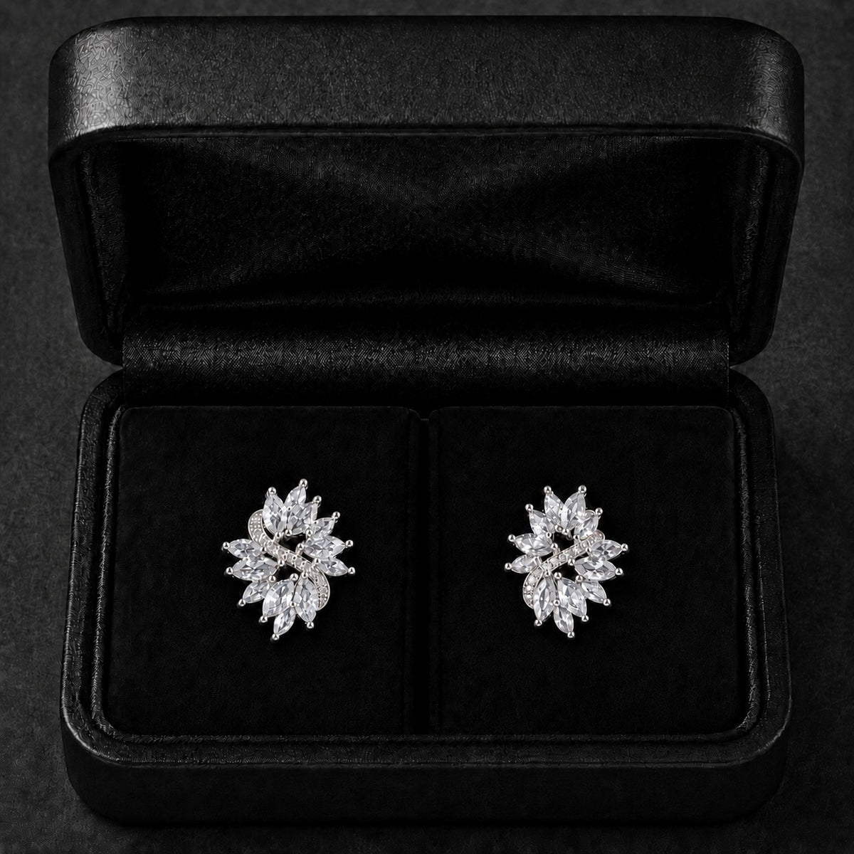 S925 Violet Arc Stud Earrings in the clear variant, featuring marquise-cut clear stones and tiny zircon detailing in a black jewellery box.