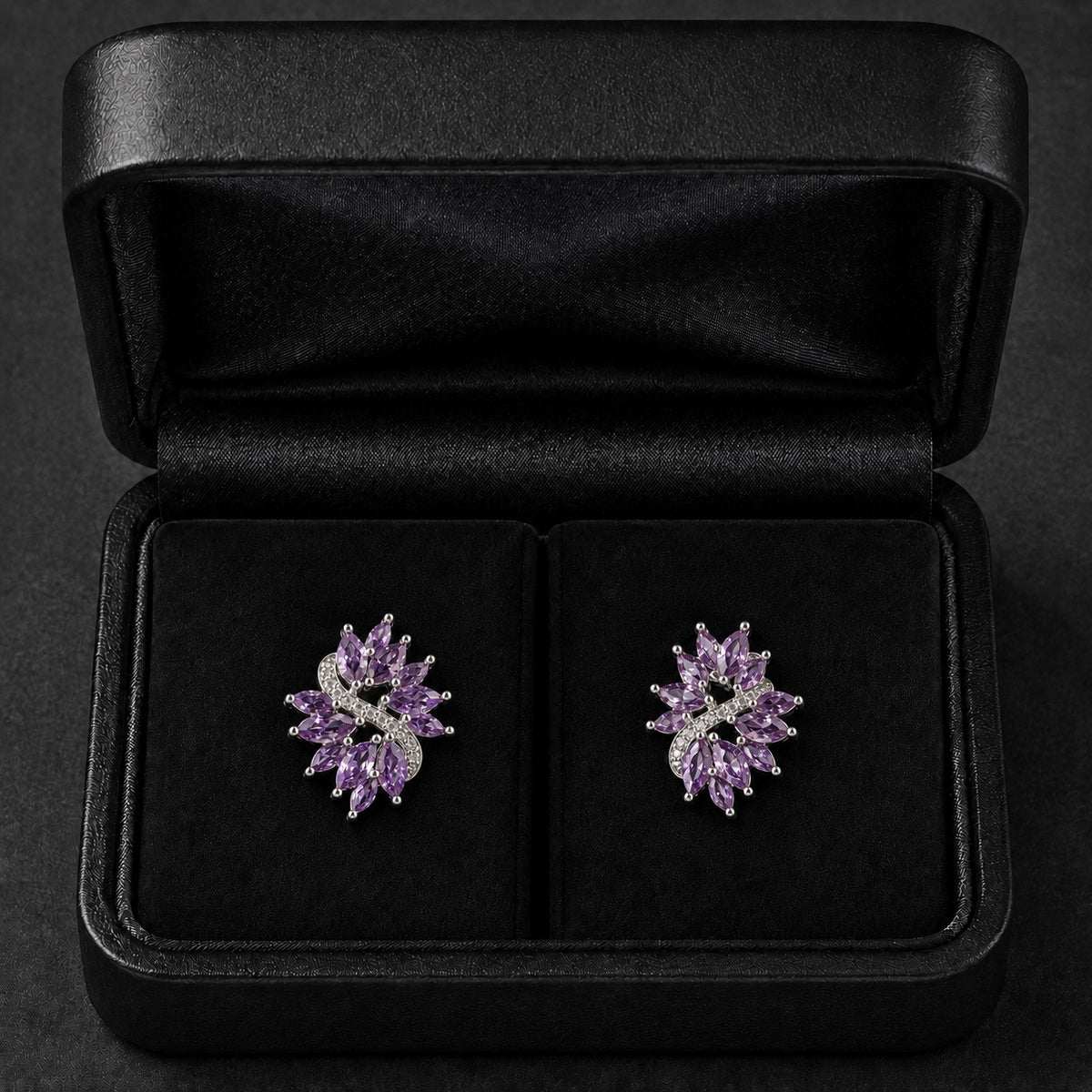 S925 Violet Arc Stud Earrings in the  purple variant, featuring marquise-cut clear stones and tiny zircon detailing in a black jewellery box