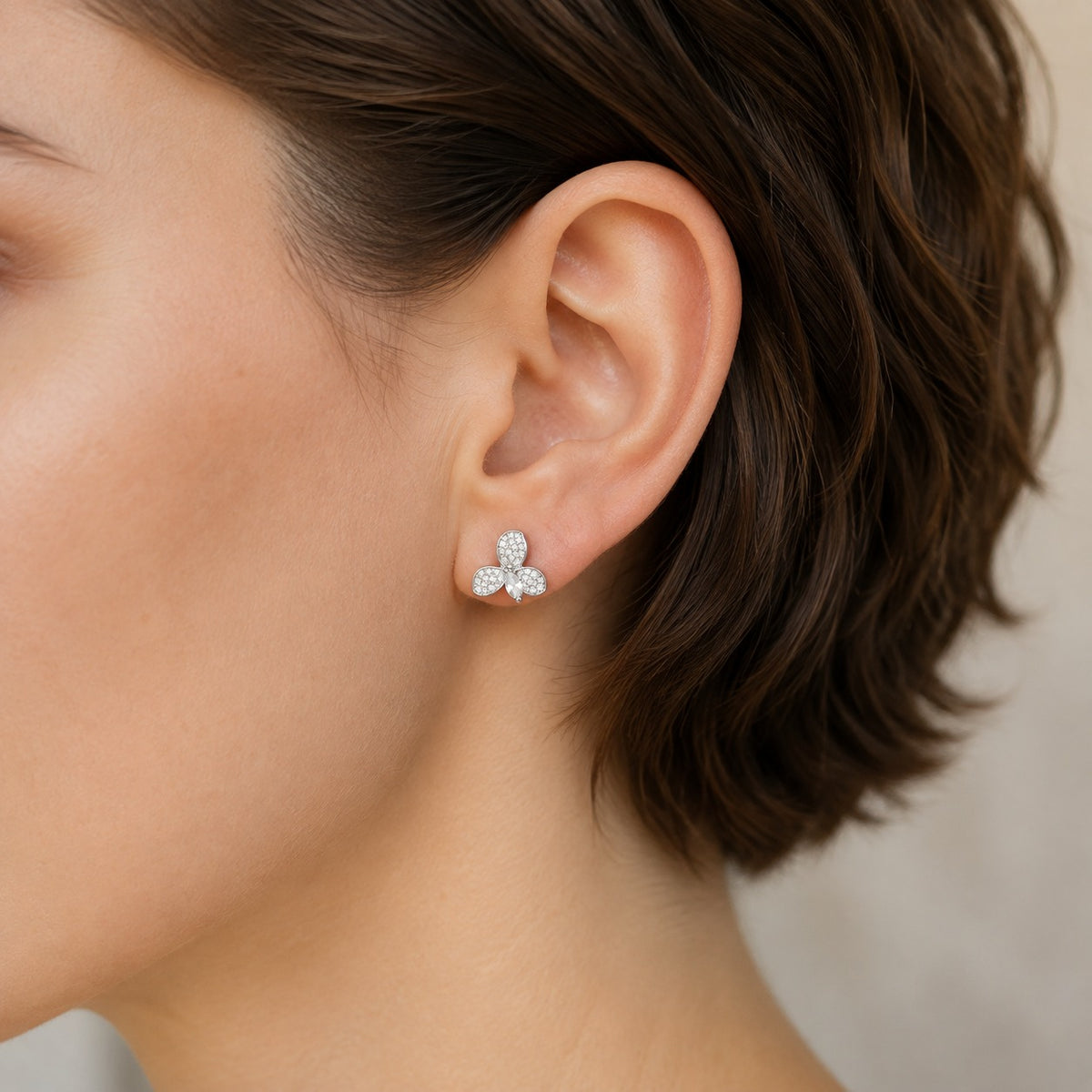  S925 Tria Glint Stud Earring worn on the ear, showing three pavé zircon sections surrounding a clear marquise-cut centre stone.
