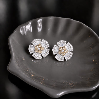 Radiant Crest Stud earrings with clear baguette zircon detailing and champagne centre stones, displayed on a smoky grey dish.