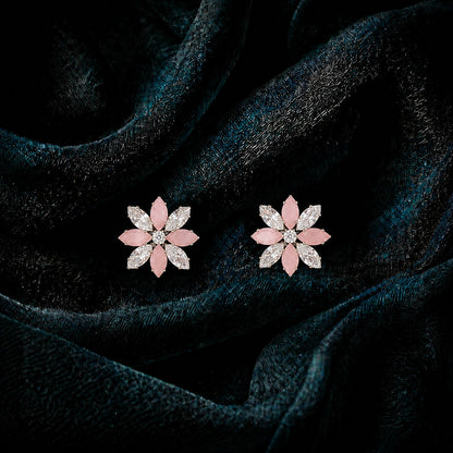 Close-up of Petal Circuit stud earrings featuring alternating coloured and clear marquise-cut stones arranged in an eight-petal floral design with a sparkling centre.