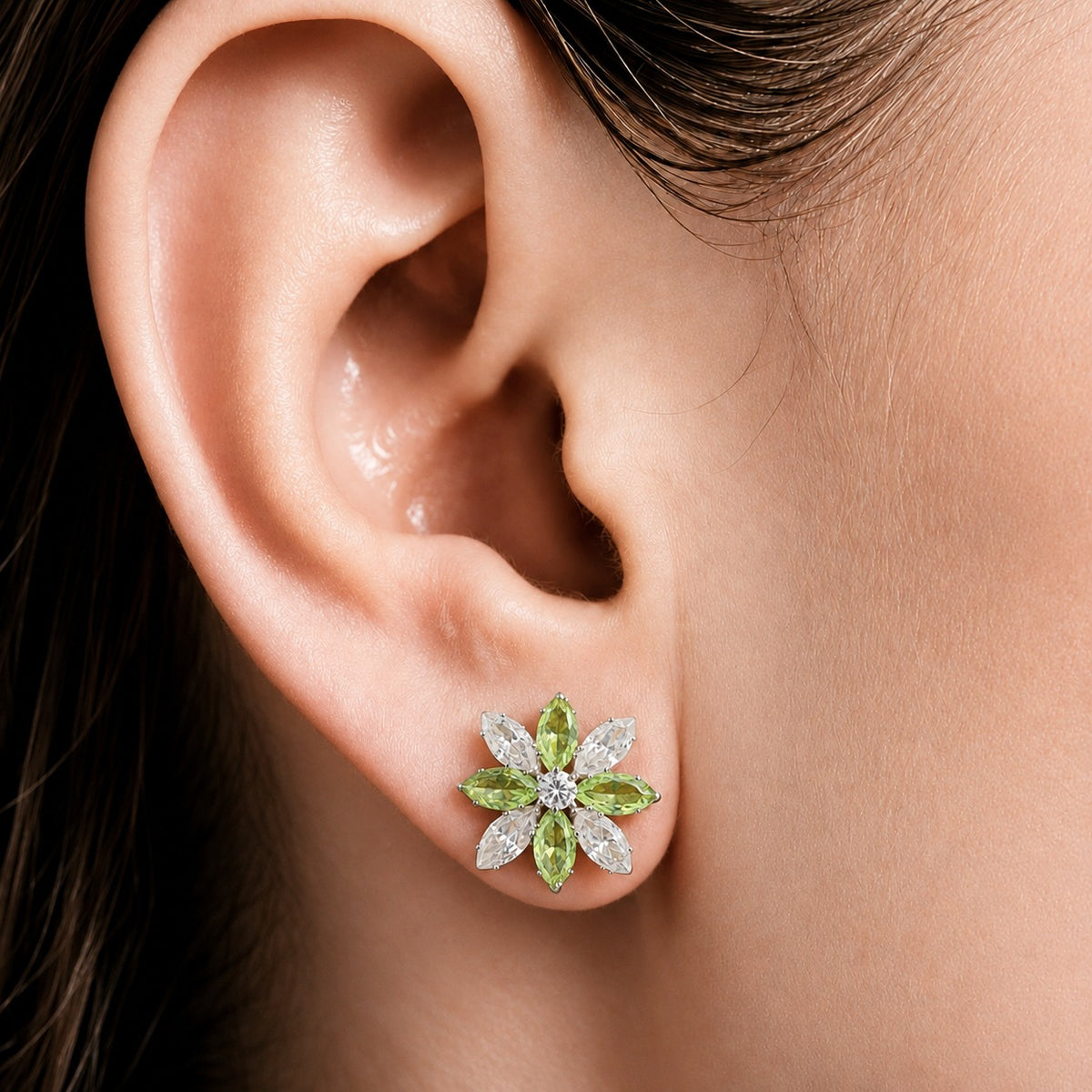 Close-up of model wearing Petal Circuit floral stud earring, showing the marquise-cut stone arrangement and compact statement size on the ear.
