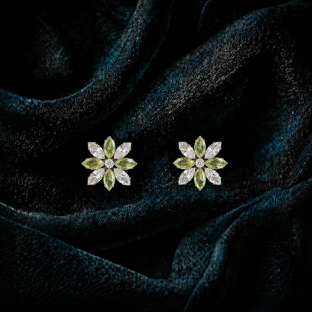 Close-up of Petal Circuit stud earrings featuring alternating coloured and clear marquise-cut stones arranged in an eight-petal floral design with a sparkling centre.