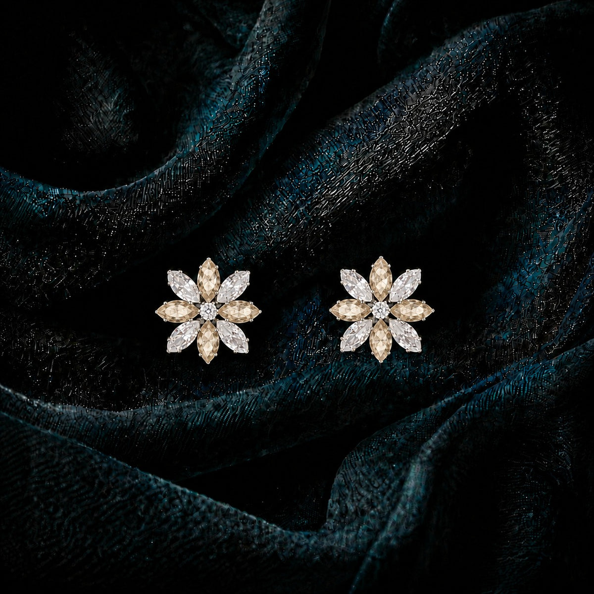 Close-up of Petal Circuit stud earrings featuring alternating coloured and clear marquise-cut stones arranged in an eight-petal floral design with a sparkling centre.