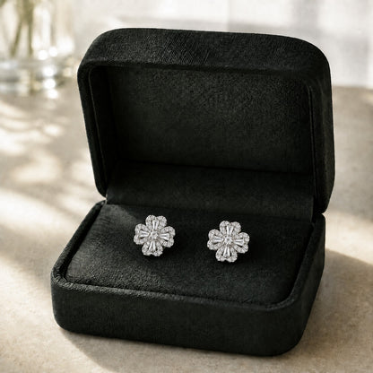 S925 silver Prism Clover Studs displayed in a black jewellery box, featuring four sculpted petals with tapered baguette and clear zircon detailing.